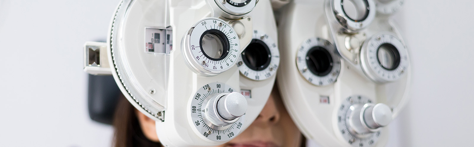An ophthalmologist s eye examination device with multiple lenses focused on the viewer.